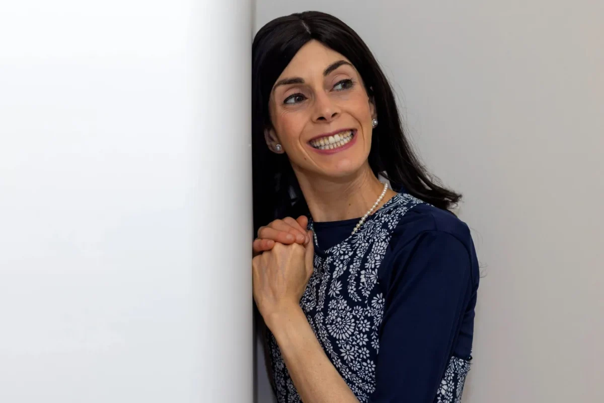 Devorah smiling with her hands folded